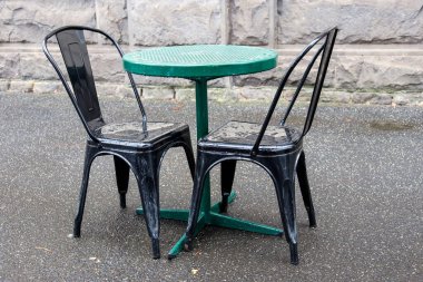 cafe outdoor dining chairs and table with no people