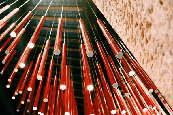 The red fluorescent tube lights hanging from the ceiling