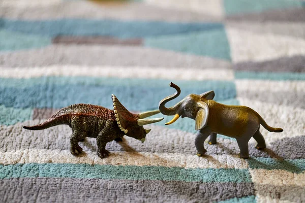 Closeup Shot Brown Triceratops Dinosaur Toy Elephant Toy Carpet Bright — Fotografia de Stock