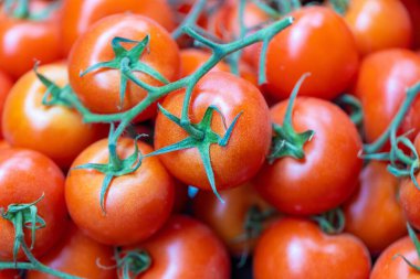 A closeup of red fresh cherry tomatoes in a market