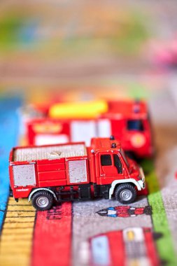 A selective focus of Siku brand red truck toys