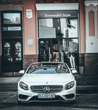 A Mercedes-Benz C-Class C300 parked in front of an Ermenegildo Zegna shop