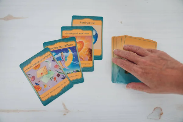 Angelic Cards Table Hand Grabbing Card High Angle Shot —  Fotos de Stock