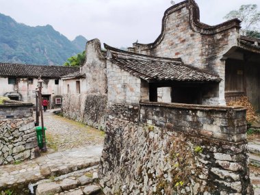 An exterior view of old stone shrine with damaged walls