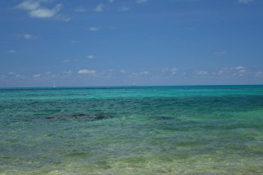 A picturesque of the clear calm turquoise blue sea against blue sky in bright sunlight in Ireland Island, Sandys Parish, Bermuda