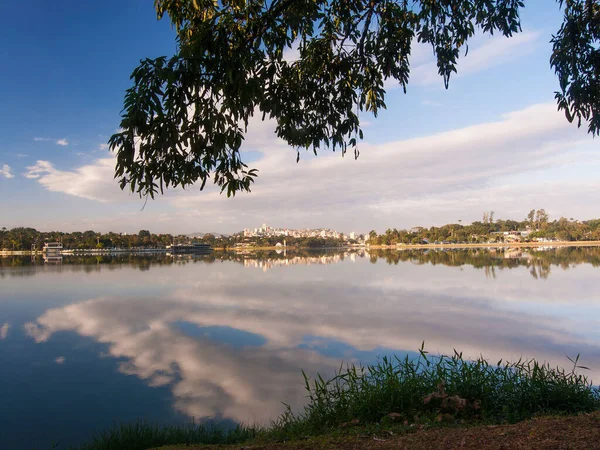 A scenic view of a lake reflecting the clouds in the sky