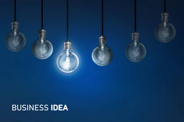 Rendering Row Dim One Bright Hanging Light Bulbs Business Idea — Zdjęcie stockowe