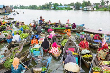 A women on boats selling products in floating market, the traditional market in Banjarmasin, South Kalimantan