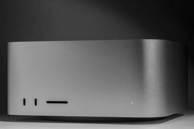 Clean box low key still life of modern new desktop computer system Mac Studio aluminium stylish Apple design product in monochrome tones