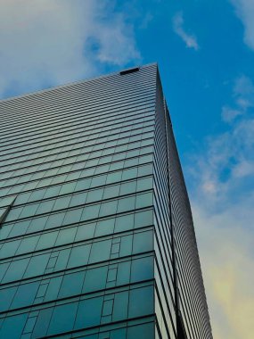A vertical low angle shot of beautiful skyscraper against a blue sky in downtown Toronto, Canada