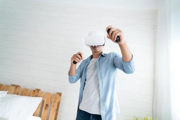 Happy Man Headset Holding Controllers Enjoying Virtual Reality Experience Bedroom — Stok fotoğraf