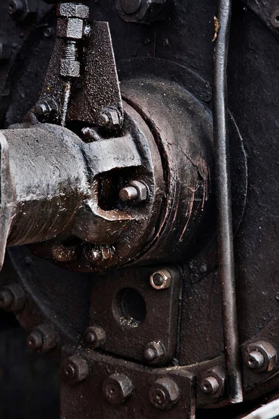 A closeup shot of an oily black metallic mechanism
