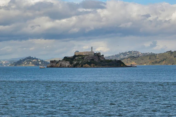 A  lake in the evening with mountains cloudy sky on the background
