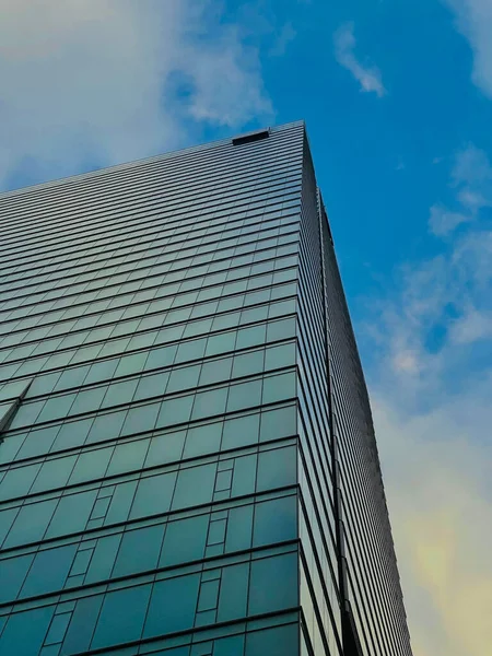 A vertical low angle shot of beautiful skyscraper against a blue sky in downtown Toronto, Canada