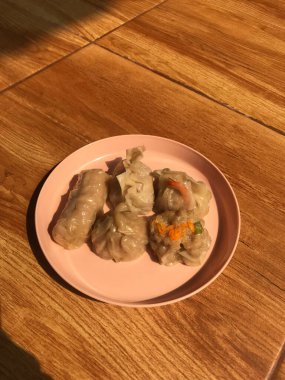 A top view of dim sum on pink plate