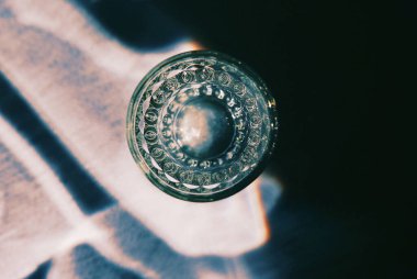 A top view of a glass cup in the sunlight