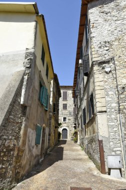 A narrow street among the old houses of Amaseno, a medieval village in the Lazio region, Italy
