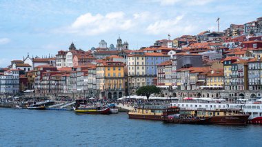 View of Riberia do Douro and cruise boats moored, Douro River, Porto, Portugal. Horizontal shot