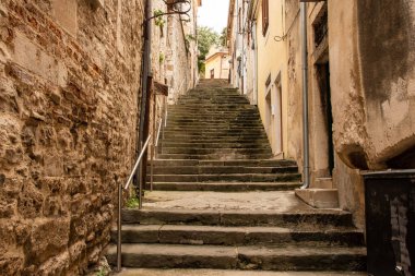 A low angle shot of the stairs in the narrow street