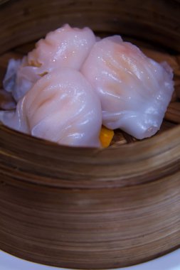A vertical closeup shot of a traditional Chinese dim sum dish in a bowl