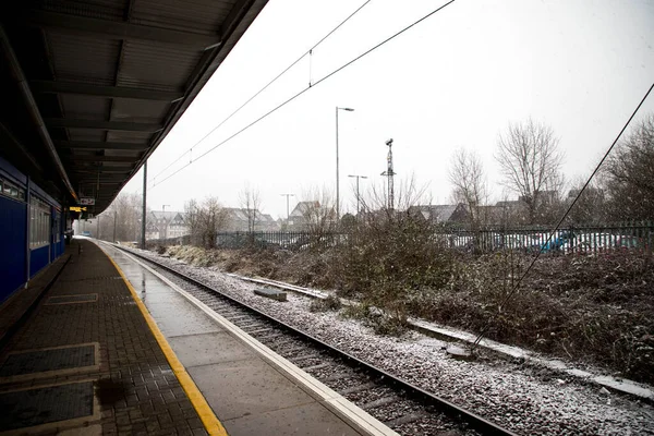 The view of the empty platform at the railway station in winter.