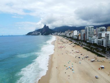 Ipanema beach in Rio de Janeiro, Rio de Janeiro State with Praia Ipanema Hotel and clouds in the sky