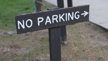 A wooden information sign with writing 