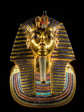 An Egyptian pharaoh Tutankhamun's burial mask isolated on black background