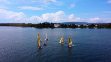 Sailing boat are learning to sail on the Annecy lake, in France