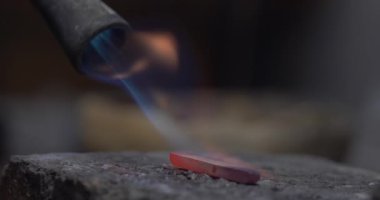 Jakarta, Indonesia-June 19, 2022: The process of softening gold bars into rings by burning