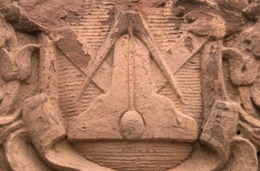 A closeup of the Square and Compass on the column of a building in Wilmington, North Carolina