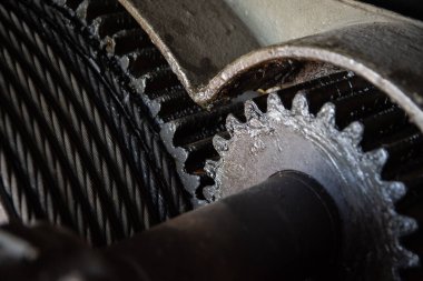 A closeup shot of greasy and oily gears for an industrial crane mechanism