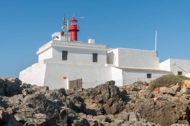 Portekiz 'deki Cascais kıyısı boyunca Cabo Raso deniz fenerinin alçak açılı bir görüntüsü.