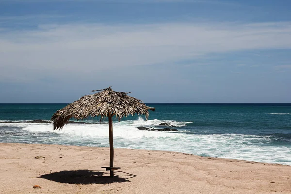 Straw Umbrella Standing Sandy Beach Sea — Zdjęcie stockowe
