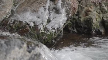 A slow motion of water flowing between rocks, river Breggia, valle di Muggio, Ticino, Switzerland