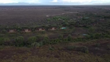 An aerial footage of a lush forest in a rural area in cloudy sky background