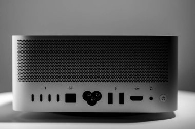 Moody image of straight frontal view of the back of contrasting low key still life of new desktop computer system