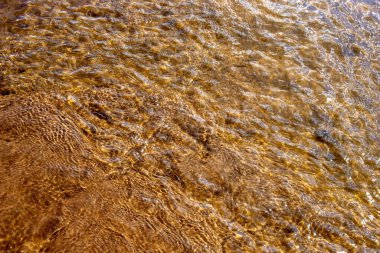Texture of water with a sand bottom in a river in Brazil.