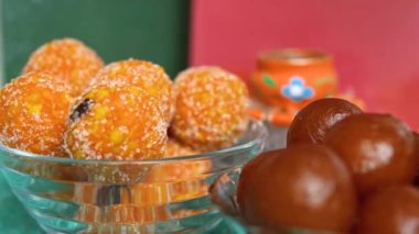 Colorful Diwali oil lamps, Deepavali oil lamps lighted in beautiful formation with bowls full of different Diwali sweets . Decorative Colorful Diya