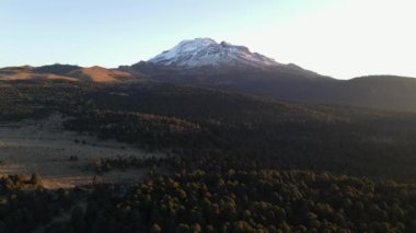 An aerial view of the rocky , snowy Iztaccihuatl volcanic mountain in Mexico in 4K
