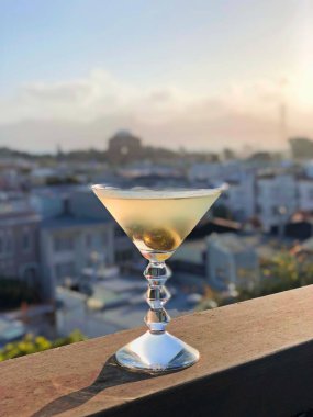 A selective focus shot of martini in glass with olives
