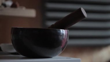 A closeup of a Tibetan bell on the blurry background