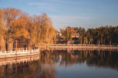 Sunset view and reflection in the lake in Beihai Park, Beijing, China
