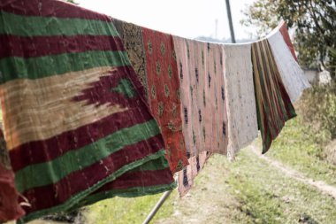 Hand made blankets in a village, hanged in a rope for drying after washing