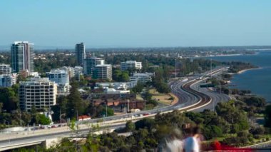 A beautiful time lapse from King's park looking away from the city at residential buildings with cars on the main road in Perth Western, Australia