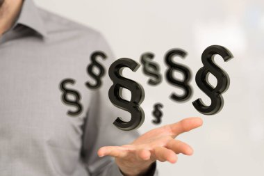 Bir elin yakınındaki illüstrasyonlu Yasaları Koruma Sembolleri 'nin yakın çekimi