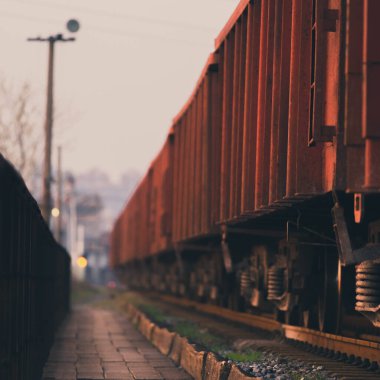A selective focus shot of train on a railroad during the sunset