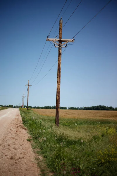 Electric Poles Empty Road Middle Field Blue Sky — Stock Photo, Image