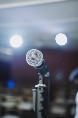 A closeup of a Microphone on a stage