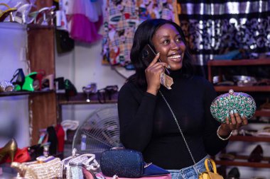 An African female making a phone call in a boutique